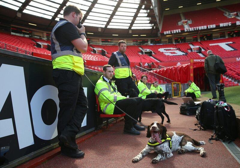A sniffer dog and patrol team wait pitchside after the match is abandoned with fans evacuated from the ground prior to the Premier League match between Manchester United and AFC Bournemouth at Old Trafford on May 15, 2016 in Manchester, England. (Alex Livesey/Getty Images)