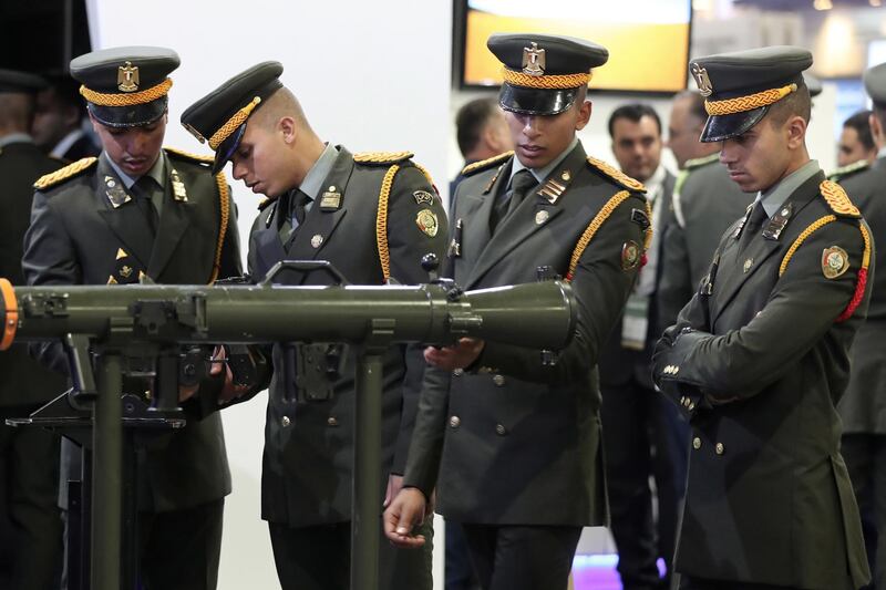 Visitors look at displayed exhibits during the EDEX Egypt Defence Exhibition 2018, in Cairo.  EPA