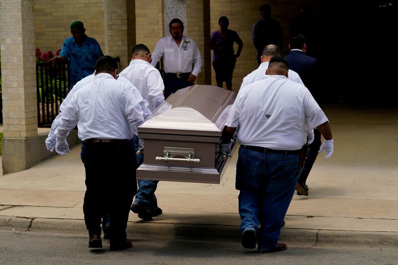 Pallbearers carry the coffin of Amerie Jo Garza into Sacred Heart Catholic Church. AP
