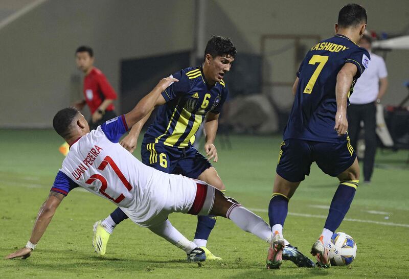 Sharjah's midfielder Luanzinho vies for the ball with Pakhtakor's defender Ibrokhimkhalil Yuldashev, centre, and Pakhtakor's forward Sardor Rashidov. AFP