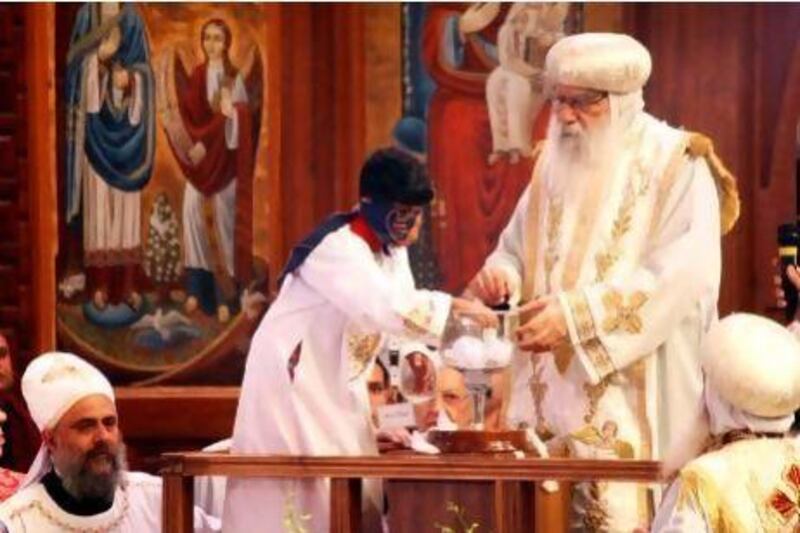 Egyptian caretaker of the Coptic Church, Bishop Pachomius, observes blindfolded altar boy Bishoy Girgis Masaad picking the name of Bishop Tawadros from a chalice as the 118th pope of Egypt's Coptic Christians.