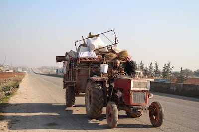 A Syrian man drives a tractor filled with personal effects as he flees bombardment in the town of Saraqib, in the northwestern Idlib province, on December 21, 2019. Tens of thousands of civilians are fleeing bombardment in Syria's Idlib region, the United Nations said, as fighting flares in the jihadist bastion, fuelling an already dire humanitarian situation. / AFP / Ibrahim YASOUF
