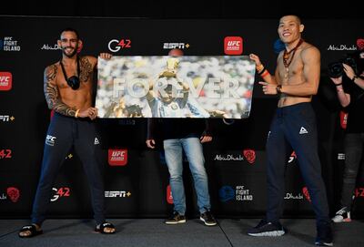 ABU DHABI, UNITED ARAB EMIRATES - JANUARY 15: (L-R) Opponents Santiago Ponzinibbio of Argentina and Li Jingliang of China hold up a sign honoring Diego Maradona during the UFC weigh-in at Etihad Arena on UFC Fight Island on January 15, 2021 in Abu Dhabi, United Arab Emirates. (Photo by Jeff Bottari/Zuffa LLC)