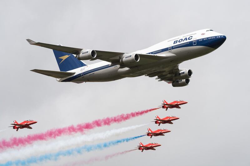 FAIRFORD, ENGLAND - JULY 20:  A British Airways special liveried Boeing 747 takes to the skies alongside the Red Arrows during the 2019 Royal International Air Tattoo on July 20, 2019 at RAF Fairford, England. The Boeing 747 has been painted in the airline's predecessor British Overseas Airways Corporation (BOAC) livery to mark British Airways' centenary this year.  (Photo by Ian Gavan/Getty Images for British Airways)