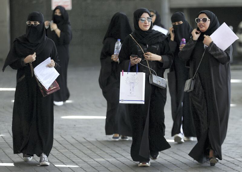 Saudi students walk at the exhibition to guide job seekers at Glowork Women's Career Fair in Riyadh, Saudi Arabia October 2, 2018. REUTERS/Faisal Al Nasser