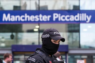 An armed police officer stands at Manchester Piccadilly railway station in Manchester, UK. Bloomberg