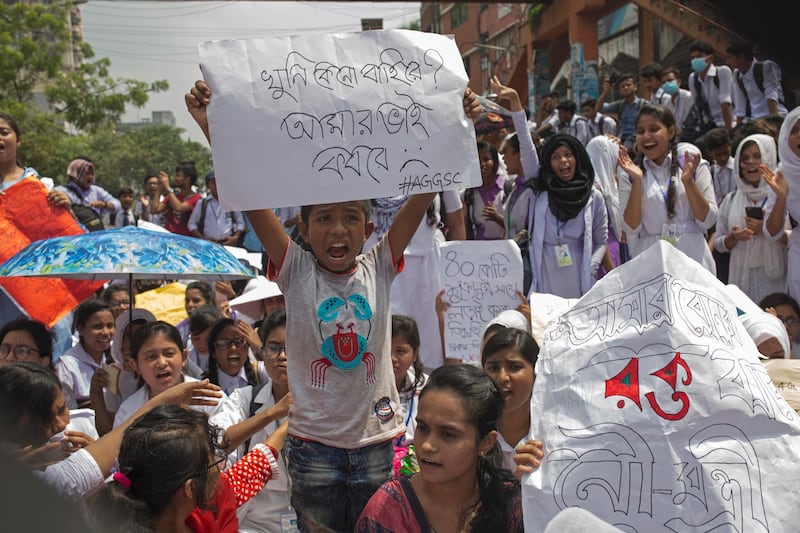 A boy holds a placard while joining a protest of hundreds of Bangladeshi students during a rally demanding safe roads on the seventh consecutive day of protests, in Dhaka city, Bangladesh.  EPA / MONIRUL ALAM