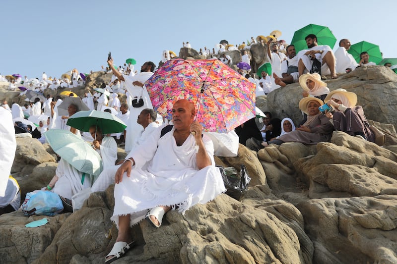 Muslim pilgrims use umbrellas to protect themselves from the heat. EPA