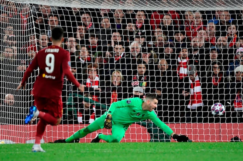 Liverpool's Spanish goalkeeper Adrian tracts as Atletico Madrid midfielder Marcos Llorente scores his team's first goal during the Champions League last 16 match.  AFP