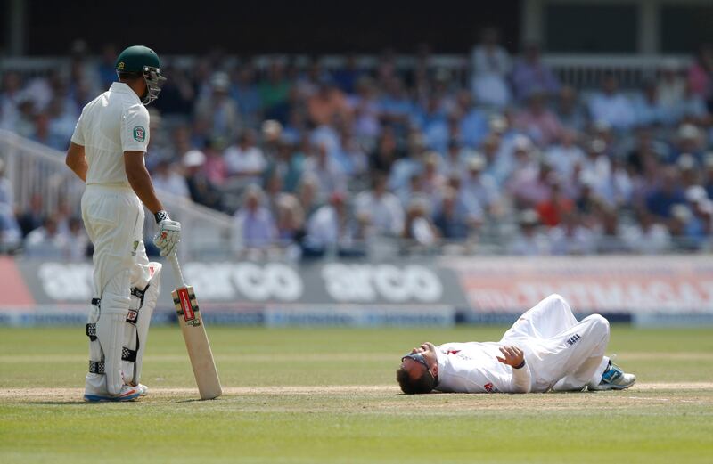 England's Graeme Swann, right, reacts to a fall as Australia's Usman Khawaja, left, looks on during day four of the second Ashes Test at Lord's cricket ground in London, Sunday, July 21, 2013. (AP Photo/Sang Tan) *** Local Caption ***  Britain Cricket England Australia.JPEG-02d3a.jpg