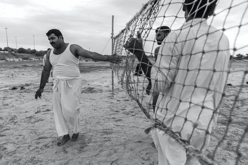 ABU DHABI, UNITED ARAB EMIRATES. 10 JANUARY 2020. Farm workers and laborers from Pakistan and India play an informal game of volleyball on a desolate patch of sand next to the Sheikh Mohammed Bin Rashid highway halfway between the Dubai and Abu Dhabi highway. (Photo: Antonie Robertson/The National) Journalist: STANDALONE. Section: Weekend.

