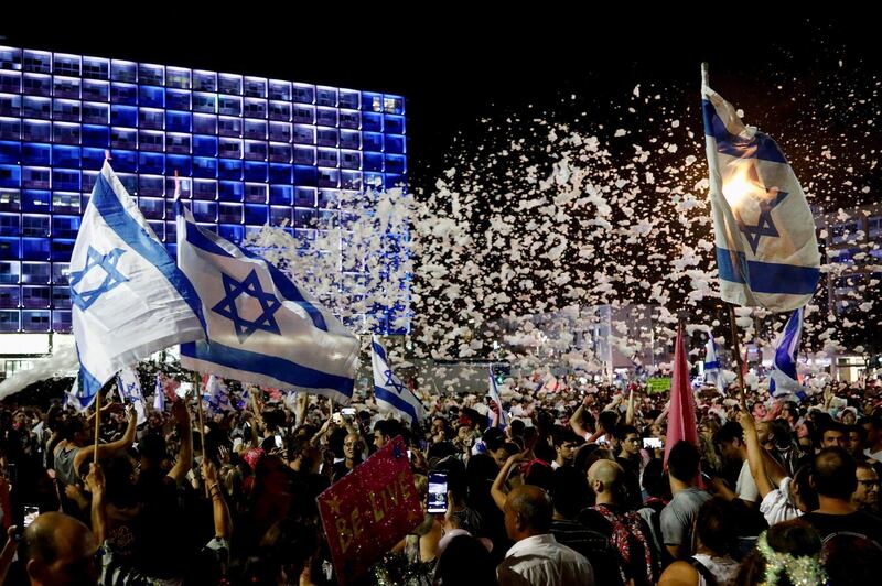 People celebrate after Israel's parliament voted in a new coalition government, ending Benjamin Netanyahu's 12-year hold on power, at Rabin Square in Tel Aviv, Israel. Reuters