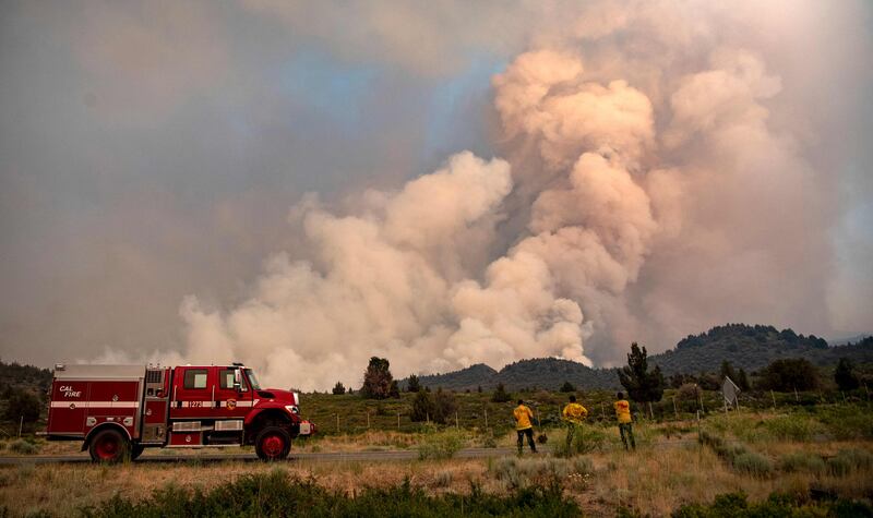 Firefighters monitor the scene as the Lava fire continues to burn in Weed, California.