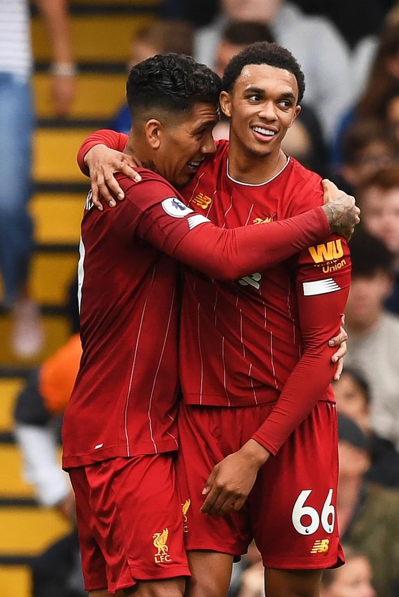 epa07861765 Liverpool's Roberto Firmino (L) celebrates with teammate Trent Alexander-Arnold (R) after scoring the 2-0 lead during the English Premier League soccer match between Chelsea FC and Liverpool FC at Stamford Bridge Stadium in London, Britain, 22 September 2019.  EPA/NEIL HALL EDITORIAL USE ONLY. No use with unauthorized audio, video, data, fixture lists, club/league logos or 'live' services. Online in-match use limited to 120 images, no video emulation. No use in betting, games or single club/league/player publications