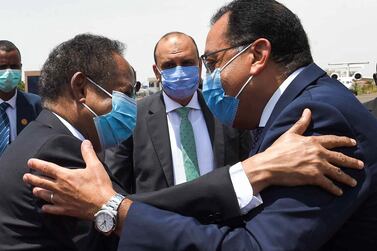 Egyptian Prime Minister Mustafa Madbouli, right, is greeted by his Sudanese counterpart Abdalla Hamdok at Khartoum International Airport on August 15, 2020. Egyptian Prime Minister's Office / AFP