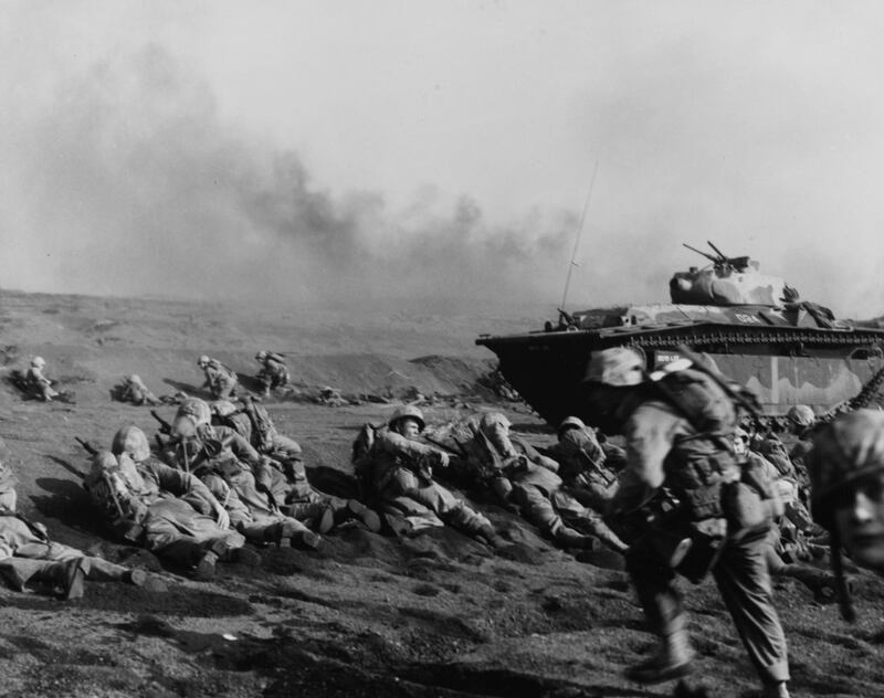 US marines of the Seventh Regiment wait to move inland on Iwo Jima soon after going ashore, on February 19, 1945. Reuters