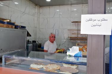 Saeed Abdallah Mussa, 59, working at his bakery in Beirut adorned with a sign that reads “we want Lebanese employees”. Sunniva Rose / The National