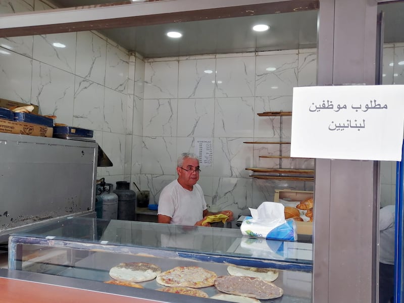 Saeed Abdallah Mussa, 59, working at his bakery in Beirut adorned with a sign that reads “we want Lebanese employees”. Sunniva Rose / The National