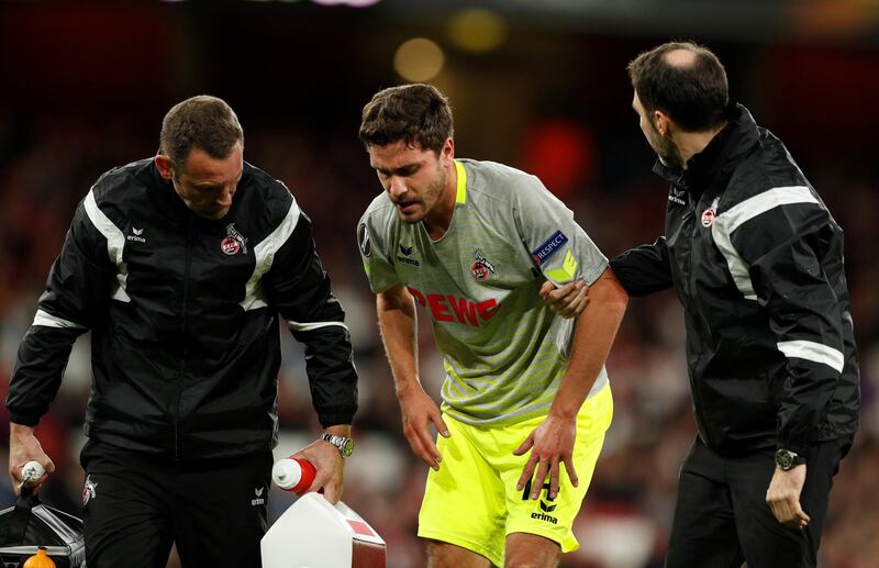 Cologne's Jonas Hector walks off the pitch with medical staff after picking up an injury. John Sibley / Reuters