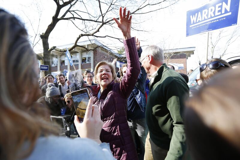 Massachusetts Senator and democratic presidential candidate Elizabeth Warren and her husband Bruce Mann greet supporters as they walk to a polling site to vote in Cambridge, Massachusetts. EPA