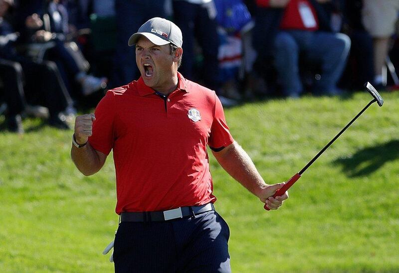 Patrick Reed of the United States reacts after making a putt on the 16th green to end the match during morning foursome matches on Day 1 of the 2016 Ryder Cup.  Jamie Squire / Getty Images / AFP / September 30, 2016