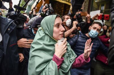 epa08415440 Italian aid worker, Silvia Romano, wearing  a Somalian garb, reacts upon her arrival at home in Milan, Italy, 11 May 2020. Silvia Romano was kidnapped by gunmen from an orphanage in Kenya for 18 months.  EPA/Matteo Corner