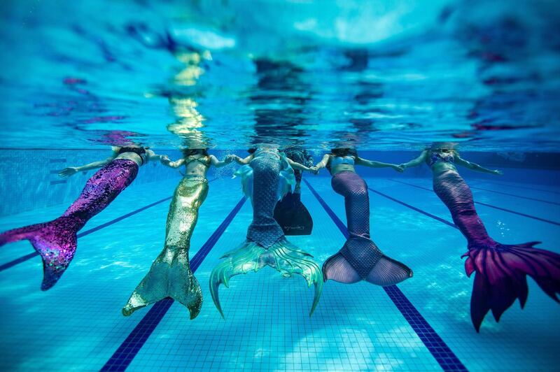 Swimmers wearing mermaid tails in a swimming pool in Klang, on the outskirts of Kuala Lumpur. AFP