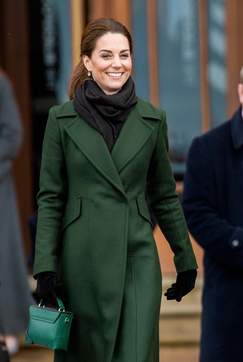 Wrapped up for a chilly public visit to Blackpool on March 6, Kate wears a moss Sportmax coat with a forest-green, top-handle bag from Turkish label Manu Atelier. EPA