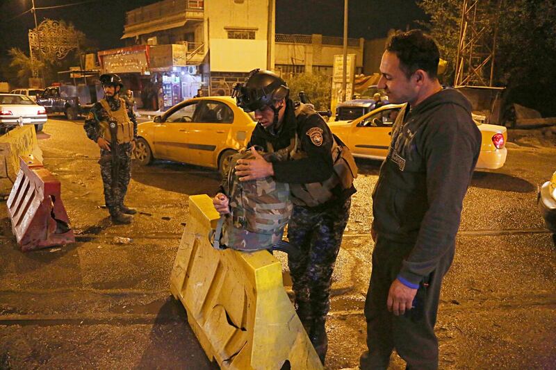 Iraqi security forces working at the scene of a suicide bombing in Baghdad, Iraq, Saturday, Jan. 13, 2018. Police and hospital officials say the Saturday blast struck a northern Baghdad neighborhood targeting a police checkpoint on a busy street, and that a number of policemen were among the wounded. (AP Photo/Karim Kadim)