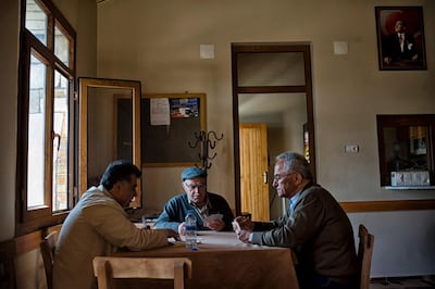 April 04, 2012.  Vakifli, Turkey - A group of Armenian men play cards in the local cafe in Vakifli, overlooked by a photograph of Kemal Ataturk.  Vakfili, a town of about 80 families near the border between Syria and Turkey, is the only Armenian village left in Turkey after the Genocide of 1915 and the pogroms that followed it. 

Courtesy Scout Tufankjian *** Local Caption ***  rv25ap-cover story-p1.jpg