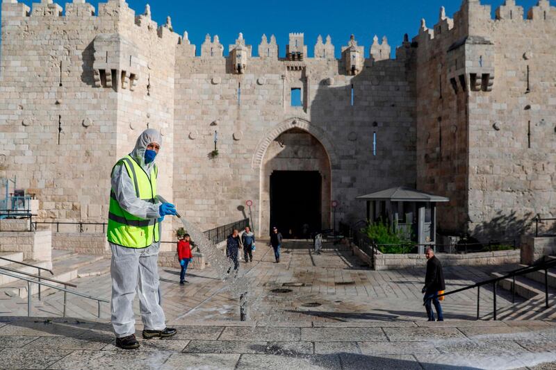 Municipal workers disinfect in front of the Damascus Gate in Jerusalem's Old City as a measure against the spread of the coronavirus.  AFP