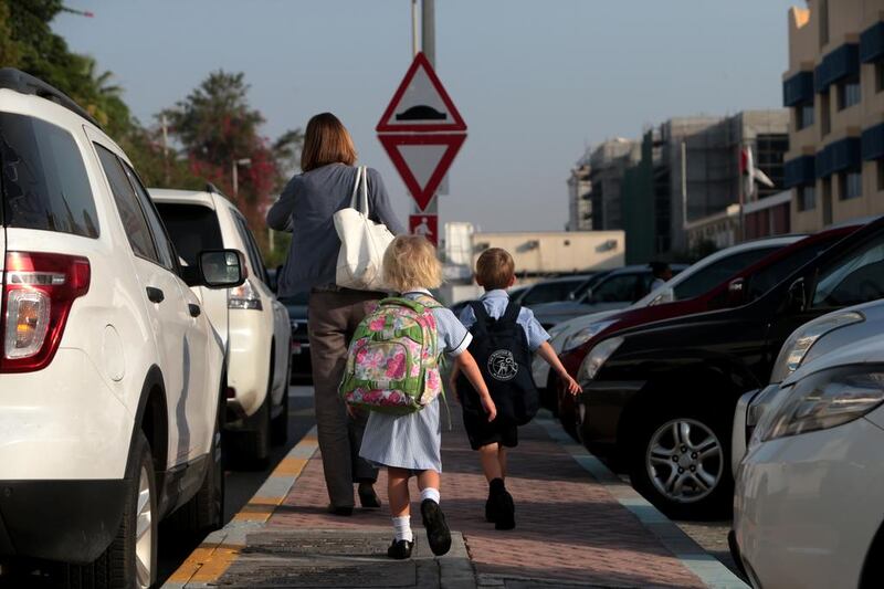 Parents drop their children off at school in Abu Dhabi. Christopher Pike / The National

