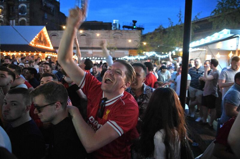 Liverpool supporters in Flat Iron Square in London react as they see their team score their second goal in Madrid AFP