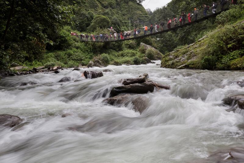 Devotees cross a suspended bridge. Narendra Shrestha/EPA
