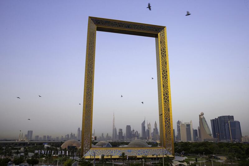 The Burj Khalifa skyscraper, center left, stands above the city skyline seen through the Dubai Frame architectural landmark in Dubai, United Arab Emirates, on Tuesday, June 19, 2018. Since the 1970s, Dubai has invested heavily in construction and infrastructure, creating a global center for finance, real estate and tourism. Photographer: Christopher Pike/Bloomberg