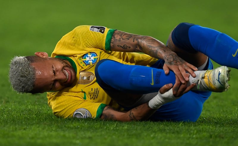 Brazil's Neymar lies in the field at the Nilton Santos Stadium in Rio de Janeiro.