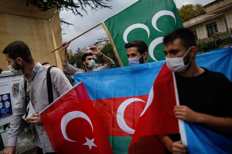 Youths from the Turkey Youth Foundation organisation chant slogans during a protest supporting Azerbaijan in front of Azerbaijan's consulate in Istanbul, Tuesday, Sept. 29, 2020. Armenian and Azerbaijani forces accused each other of attacks on their territory Tuesday, as fighting over the separatist region of Nagorno-Karabakh continued for a third straight day following the reigniting of a decades-old conflict. (AP Photo/Emrah Gurel)