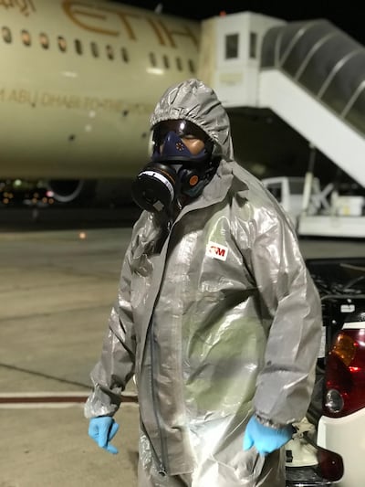 Cleaning crew wear hazmat suits and masks to enter aircraft coming from high-risk detinations.