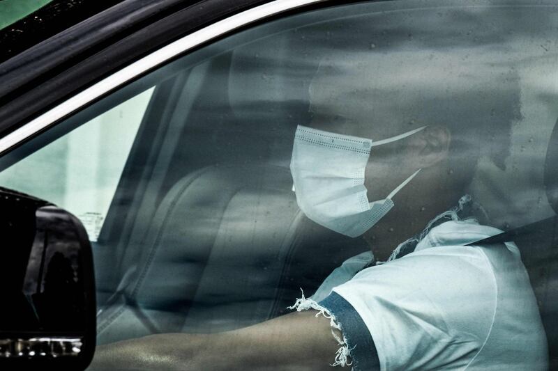 Juventus' Colombian midfielder Juan Cuadrado, wearing a face mask, arrives in his car. AFP