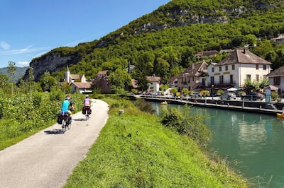 Chanaz (Savoy, French Alps): cyclists along the Savieres canal, on the opposite bank of the village. (Photo by: Andia/UIG via Getty Images)