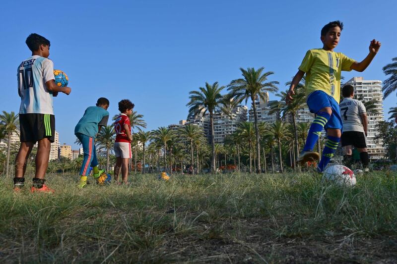 Children play football at the Montazah Royal Gardens in the northern Egyptian city of Alexandria.  AFP