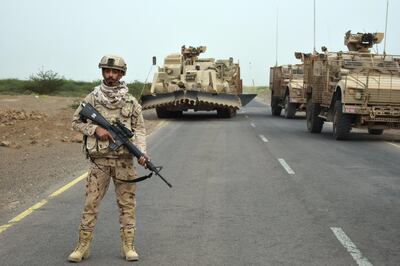 A UAE soldier stands guard as his team prepare to sweep a suspected Houthi minefield near Al Mokha, Yemen. Gareth Browne/The National