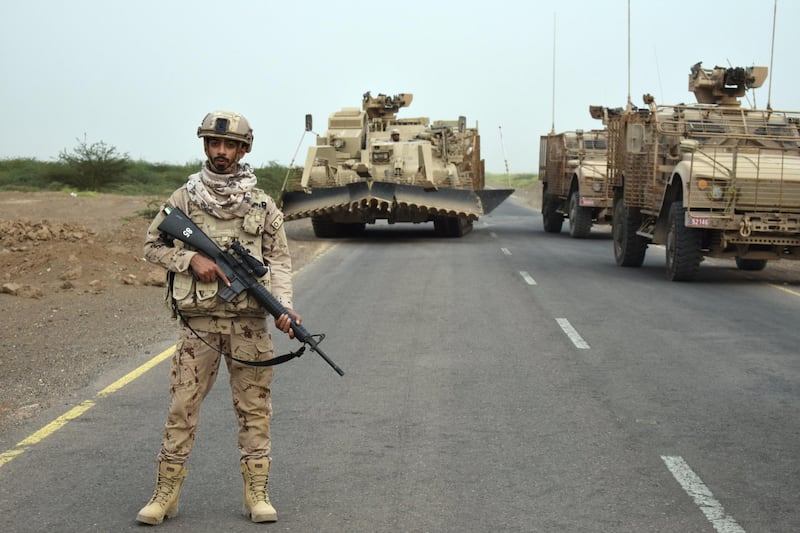 A UAE soldier stands guard as his team prepare to sweep a suspected Houthi minefield near Al Mokha, Yemen. Gareth Browne / The National