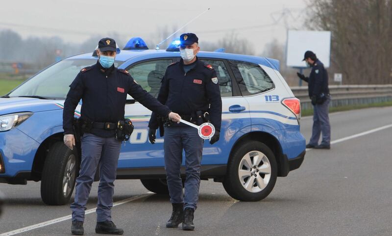 Italian police at the entrance to the small town of Casalpusterlengo, south-east of Milan, on Sunday, as Italy took drastic containment steps to fight the outbreak. EPA