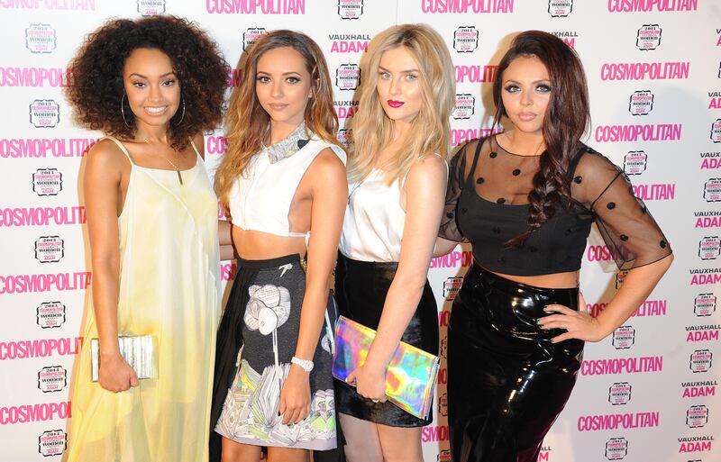 Jesy Nelson, in a black vinyl skirt and sheer top, with her Little Mix bandmates, attends the Cosmopolitan Ultimate Women of the Year Awards on December 5, 2013