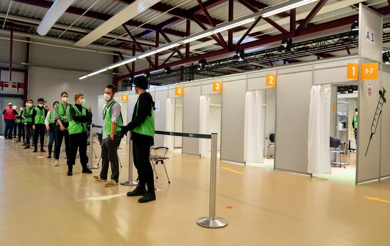 Volunteers wait for visitors at the Covid-19 vaccination center, set up inside the former Tegel Airport, in Berlin, Germany. Bloomberg
