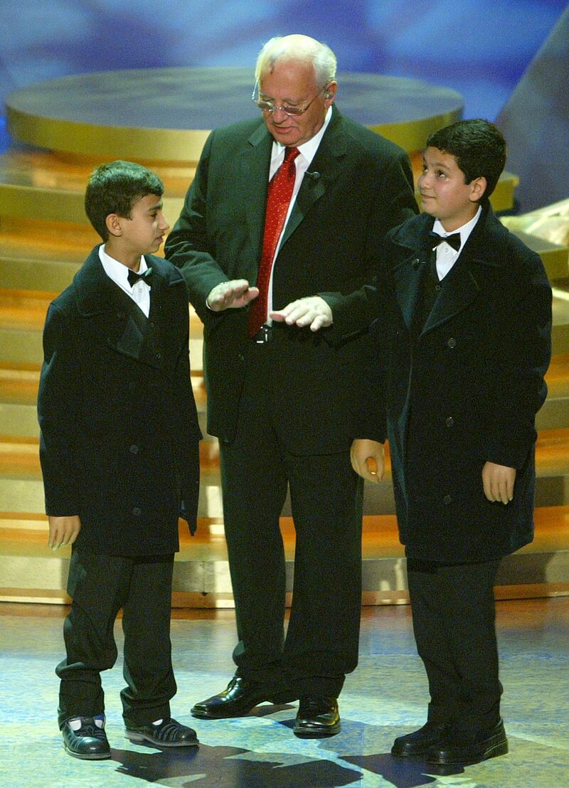 Mr Gorbachev (centre) speaks with Iraqi boys Ali Ismael Abbas (right) and his friend Ahmed (left) during an awards ceremony where Dr Ahmed Al Shatti, representing Iraqi and Kuwaiti doctors, was honoured with the "Men of the year award" for work during the Iraq war at the World Awards gala in Hamburg on October 22, 2003. Reuters