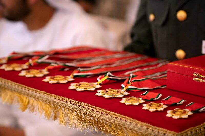 ABU DHABI, UNITED ARAB EMIRATES - April 08, 2019: A member of the UAE Armed Forces presents an Emirates Military Medals, during a Sea Palace barza.

( Ryan Carter / Ministry of Presidential Affairs )
---