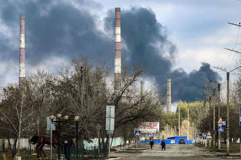 Smoke rises from a power plant after shelling outside the town of Schastia, a day after Moscow recognised two Ukrainian separatist republics and ordered the Russian Army to send in troops as ‘peacekeepers’. AFP