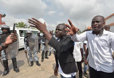 Men gesture as victims and relatives of victims of the 2011 post electoral violences arrive to protest against a request to release former Ivory Coast's president Laurent Gbagbo in front of the Conseil National des Droits de l'Homme (Human Rights Council - CNDH) on January 14, 2019 in Abidjan.   ICC in The Hague is to rule on release of former Ivory Coast president Laurent Gbagbo on January 15, 2019. / AFP / Sia KAMBOU
